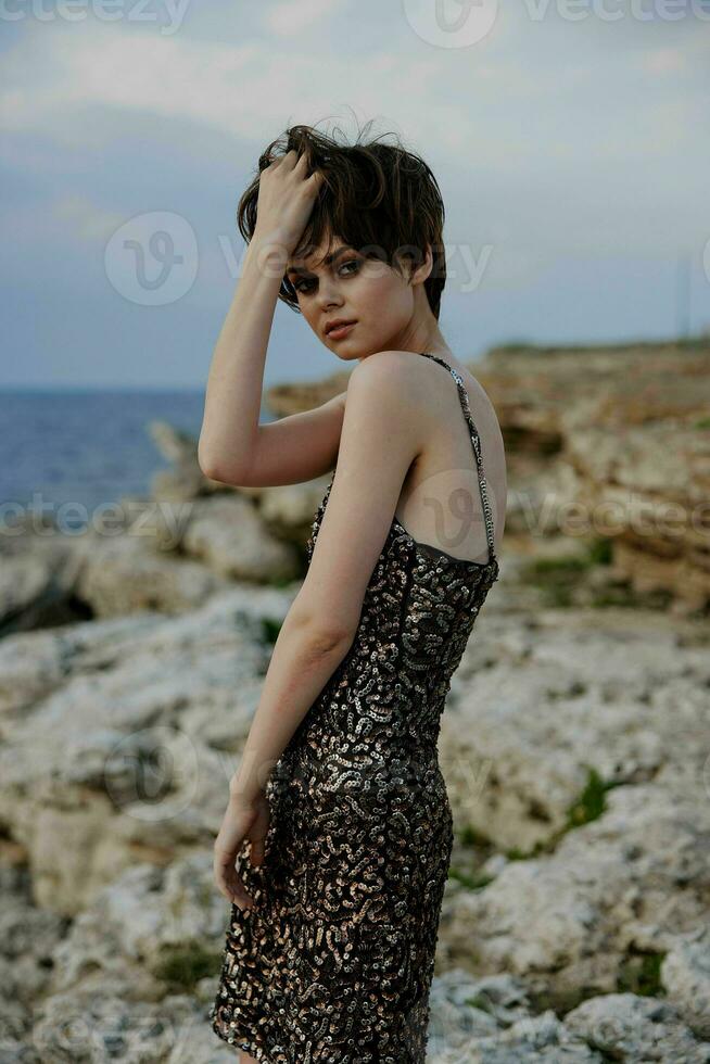 woman with makeup in dress on nature rocks landscape elegance photo