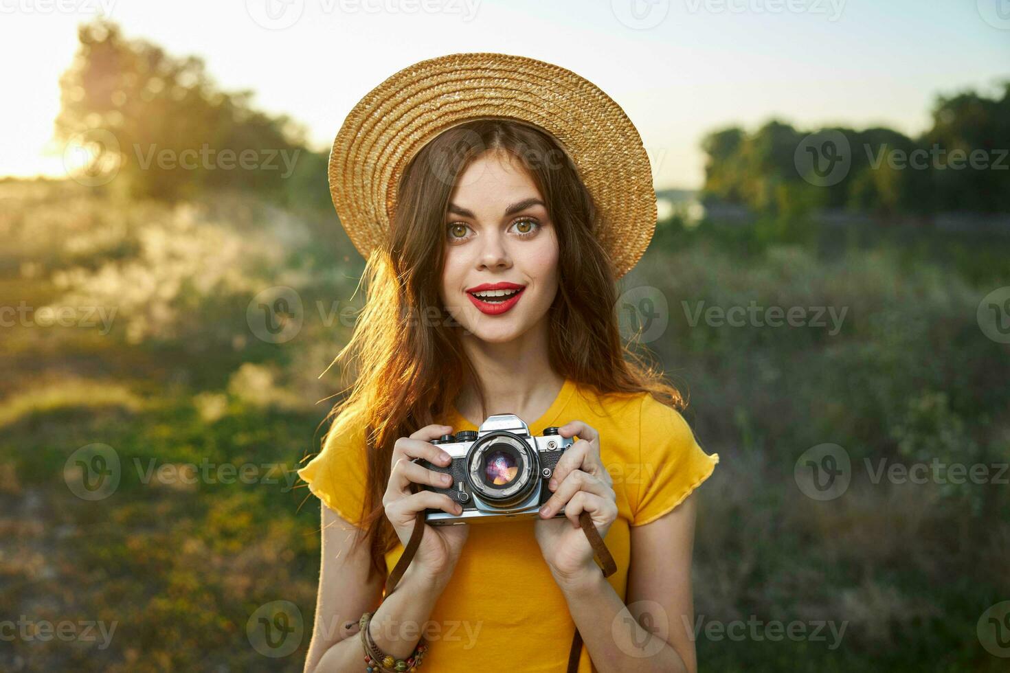 pretty woman holding camera in hands nature fresh air lifestyle photo