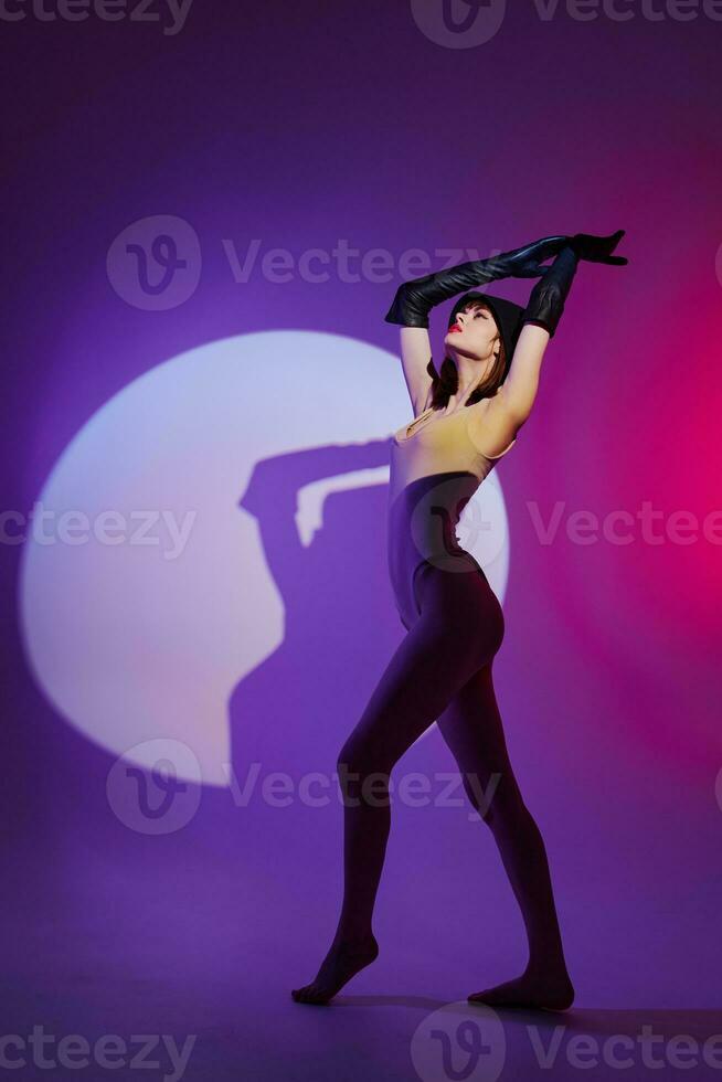 Pretty young female posing on stage spotlight silhouette disco purple background unaltered photo
