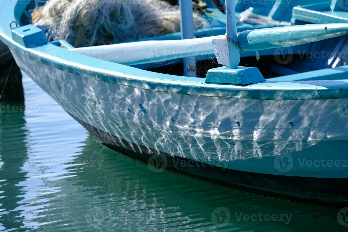 Sea water reflections on the side of a wooden fishing boat in Lefkada in Greece photo