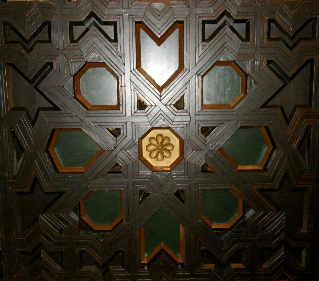 Dark wood color coffered ceiling with gold trim photo