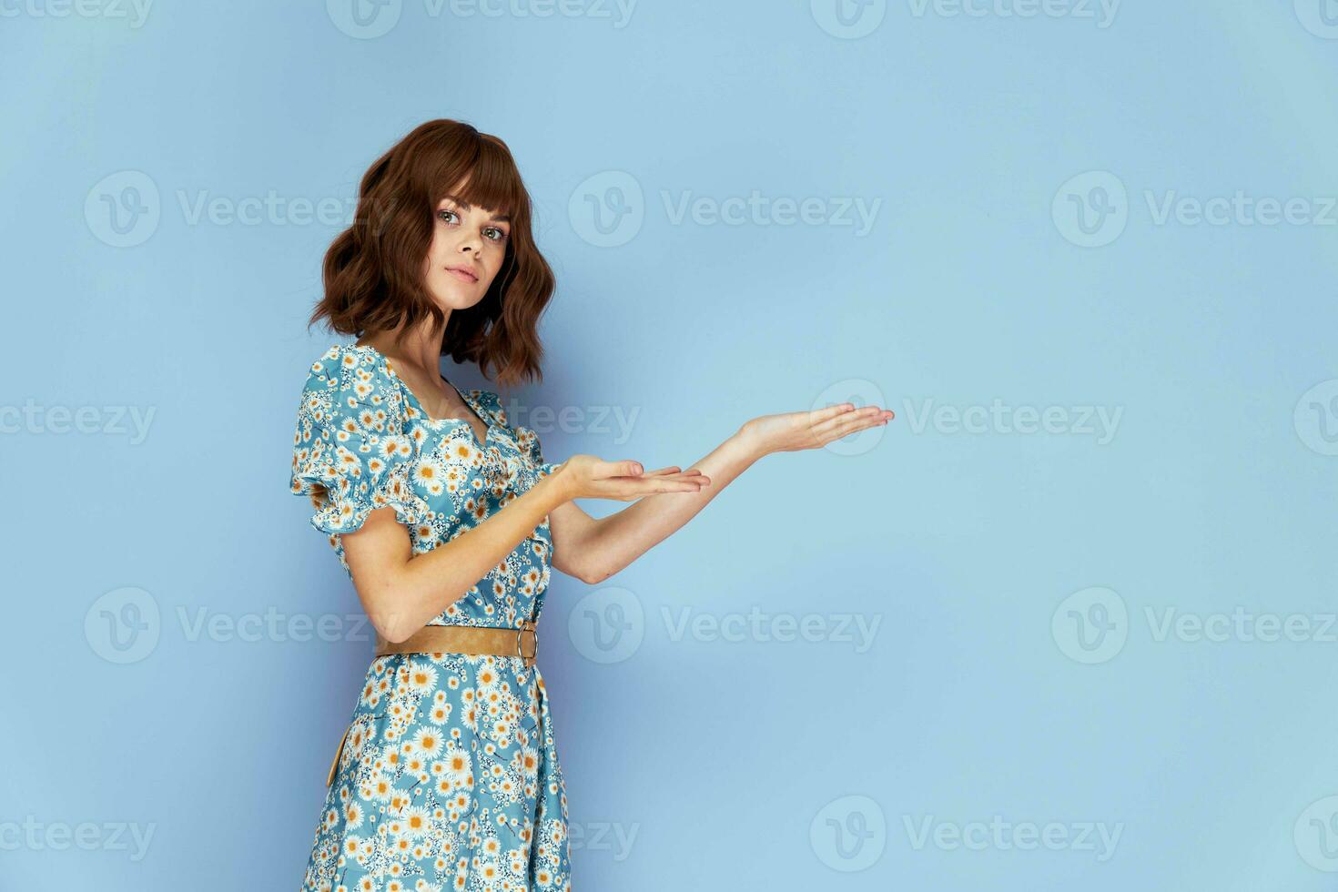 Beautiful woman The woman holds her hands in front of her, palms up summer clothes photo