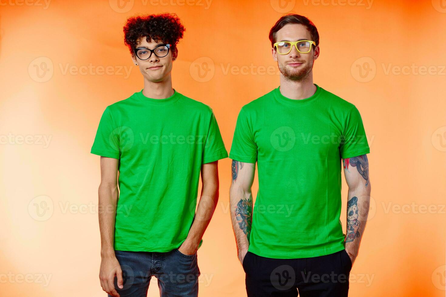 two friends with glasses in green t-shirts are standing next to fashion photo