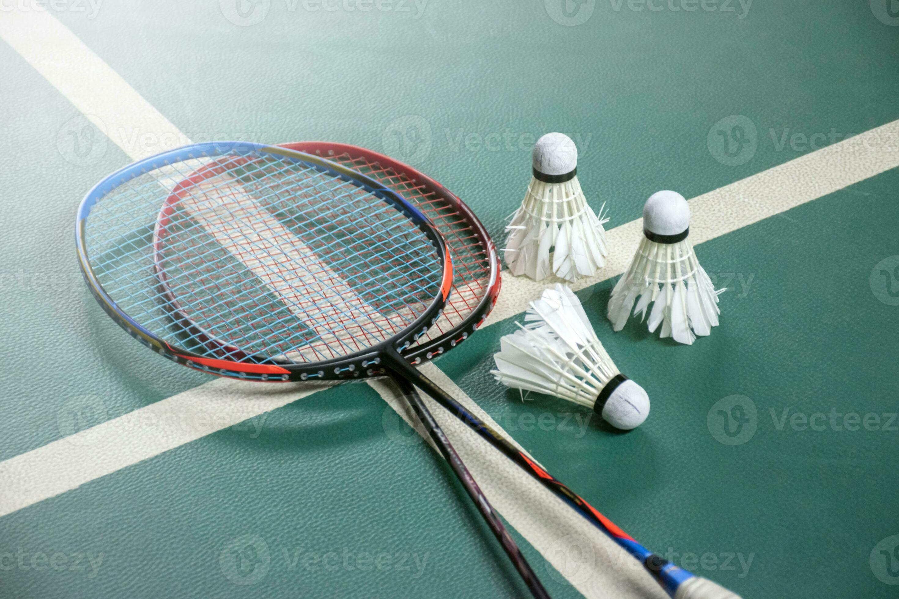 Badminton rackets and white cream badminton shuttlecocks after playing