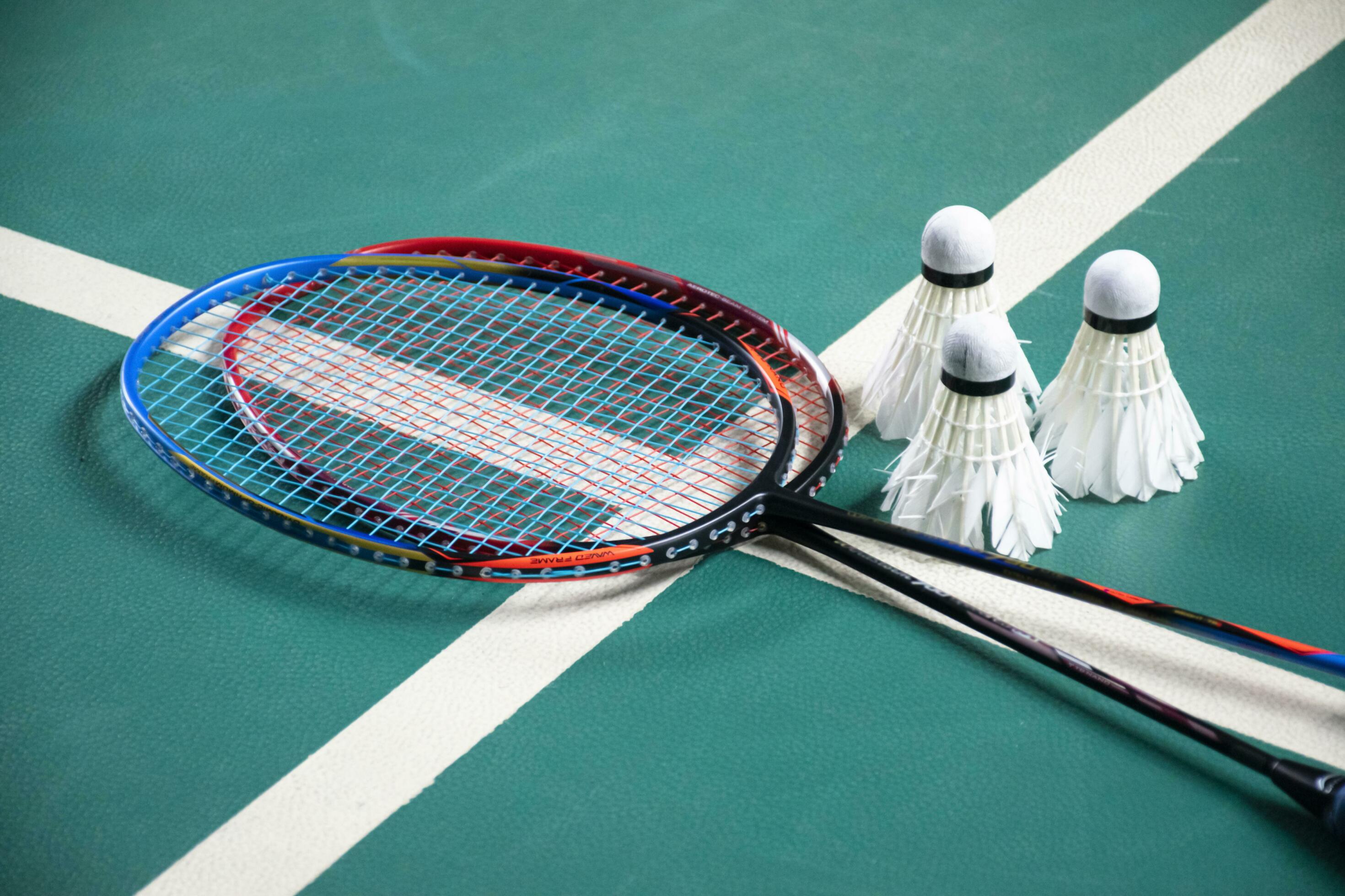 Badminton rackets and white cream badminton shuttlecocks after playing