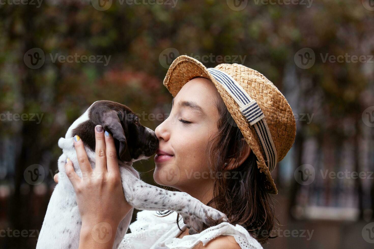 Beautiful young girl having fun with her small French Braque puppy photo