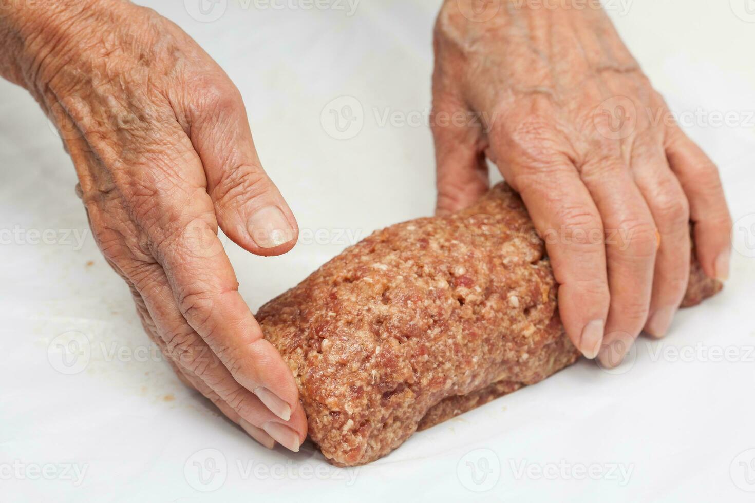 Preparation of a baked egg and vegetables stuffed meatloaf covered with bacon. Meat roll photo