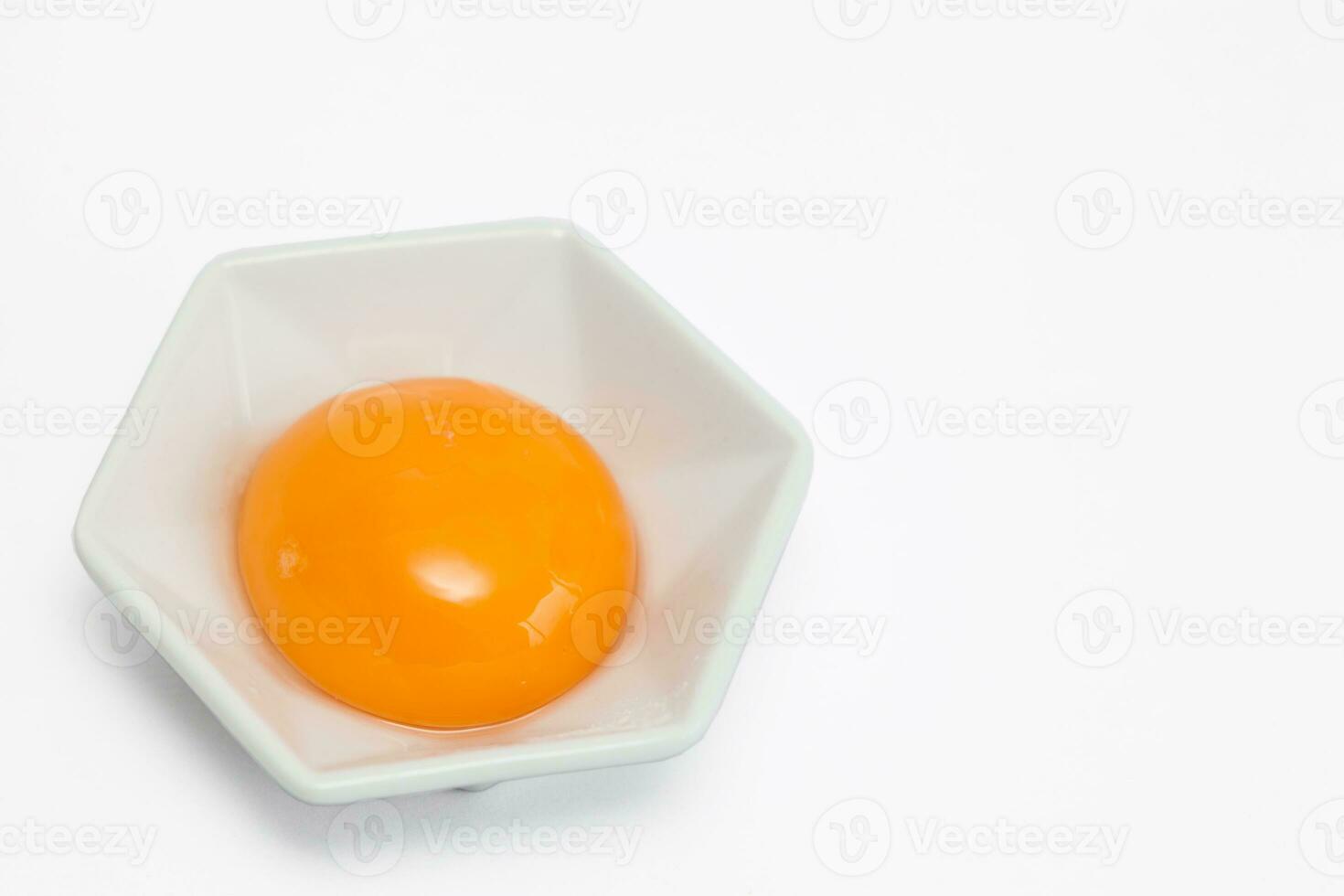 Egg yolk in white background photo