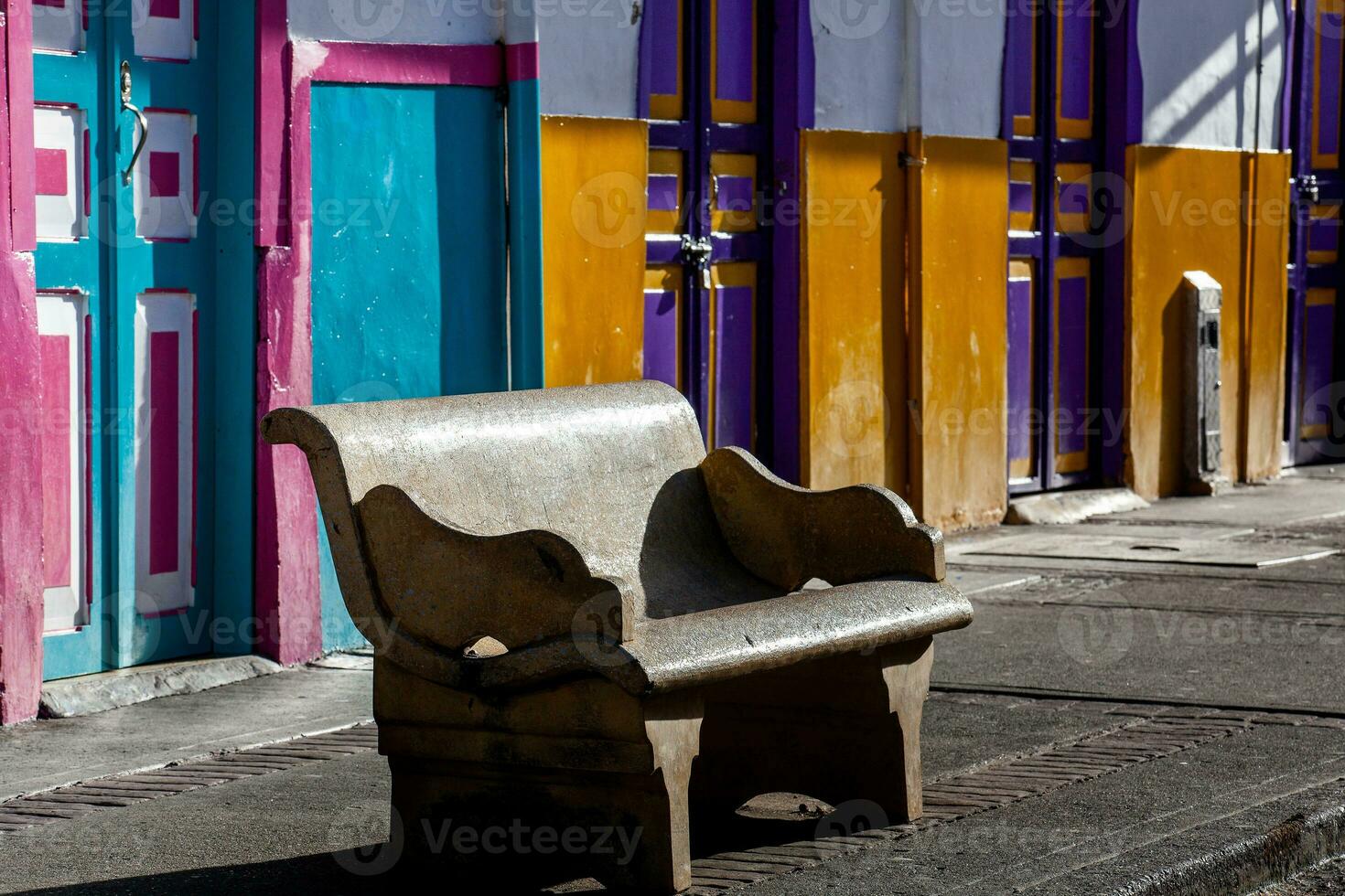 Empty bench at a beautiful street of the small town of Salento located at the region of Quindio in Colombia photo