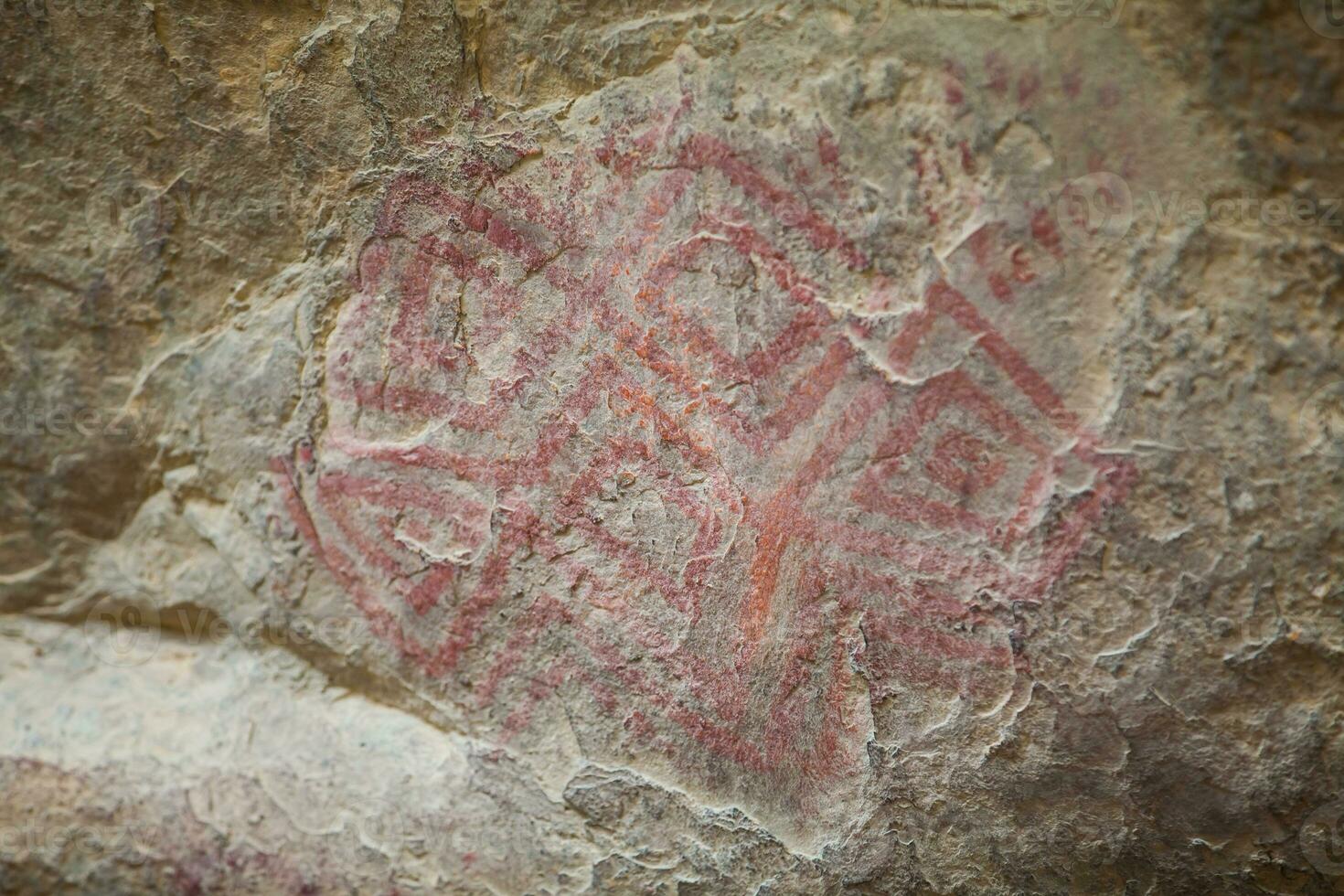 Prehistoric paintings on rock known as petroglyphs in Colombia photo