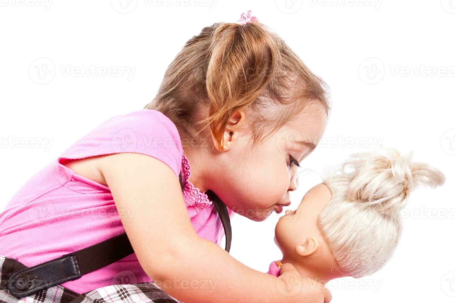 Sweet little blonde girl playing with dolls photo