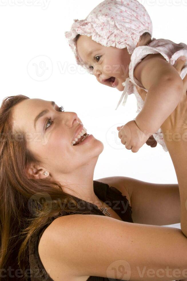Happy beautiful young mother and her baby girl on white background photo