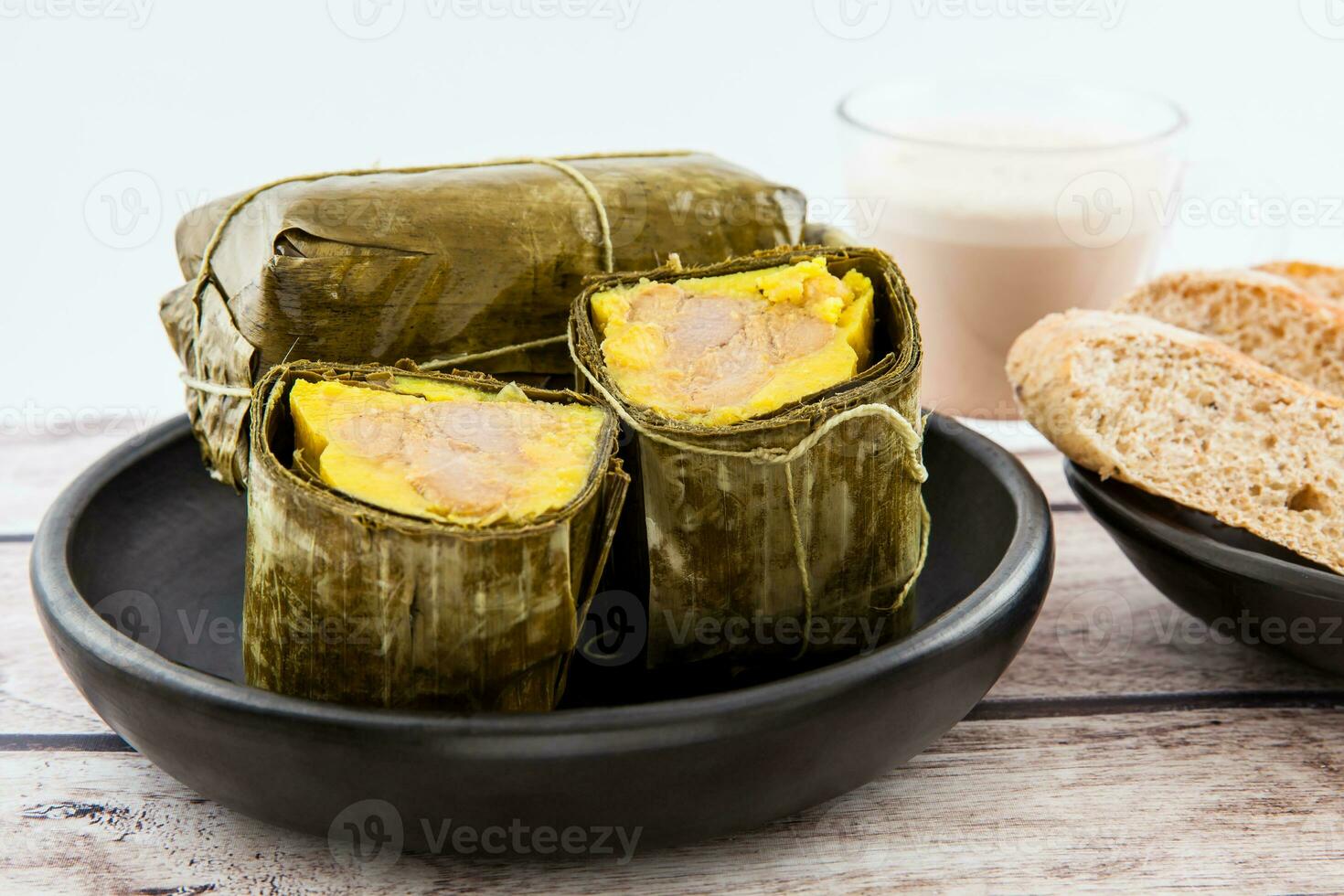 Traditional Colombian tamale breakfast with bread and chocolate as made on Santander region isolated on white background photo