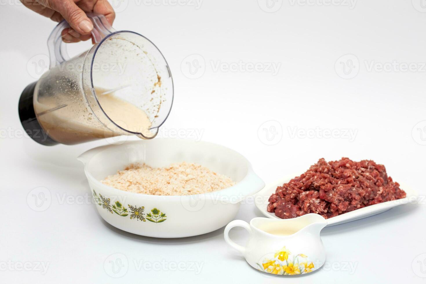 Preparation of a baked egg and vegetables stuffed meatloaf covered with bacon. Meat roll photo