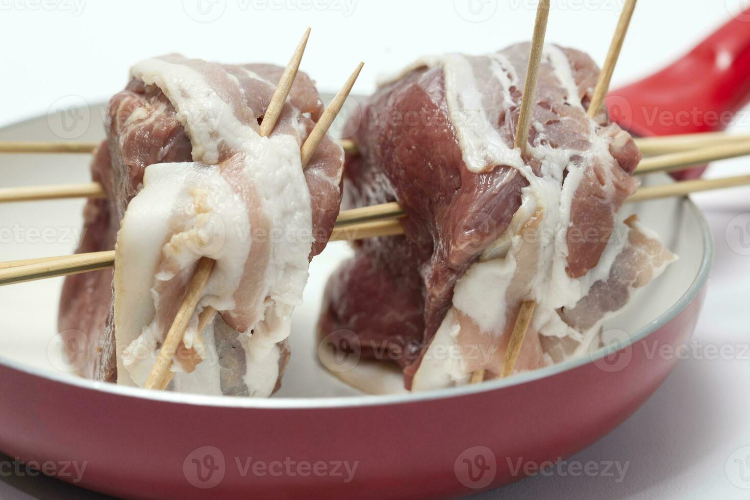 Raw beef tenderloin medallions wrapped in pork bacon. Fillet Mignon Preparation photo