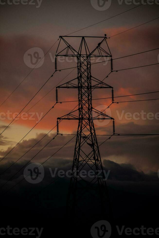 Power tower against a dramatic beautiful sunset sky photo