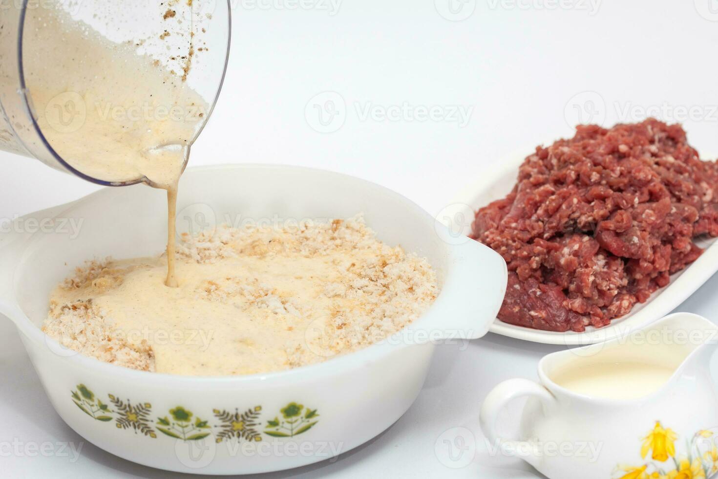 Preparation of a baked egg and vegetables stuffed meatloaf covered with bacon. Meat roll photo