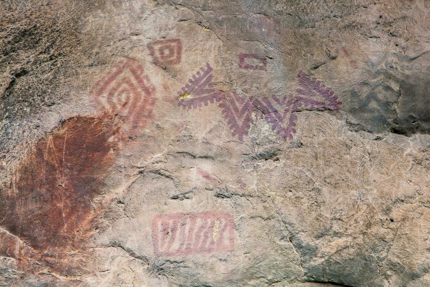 Prehistoric paintings on rock known as petroglyphs in Colombia photo