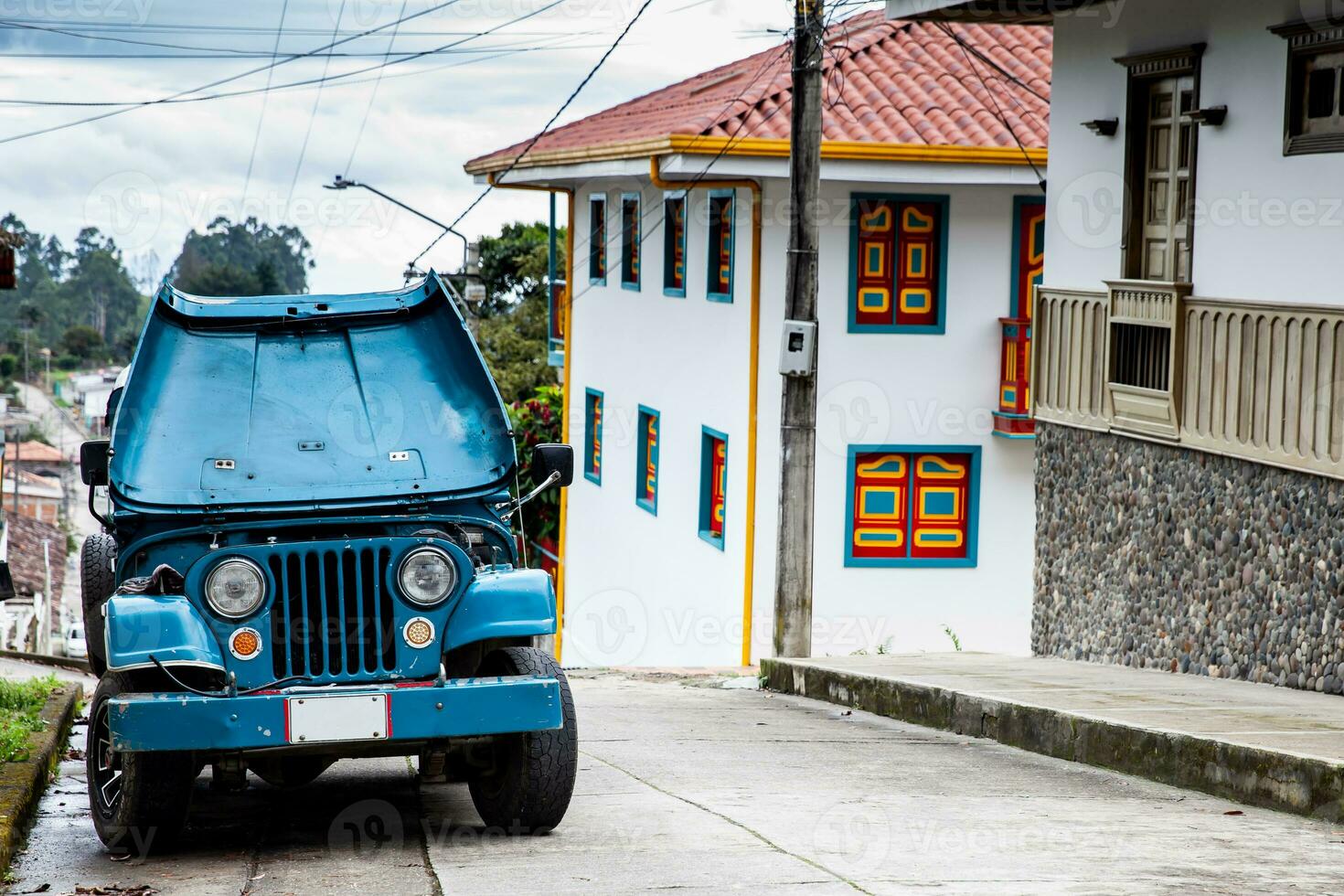 Traditional off-road vehicle parked at a beautiful street in the small town of Salento located at the region of Quindio in Colombia photo