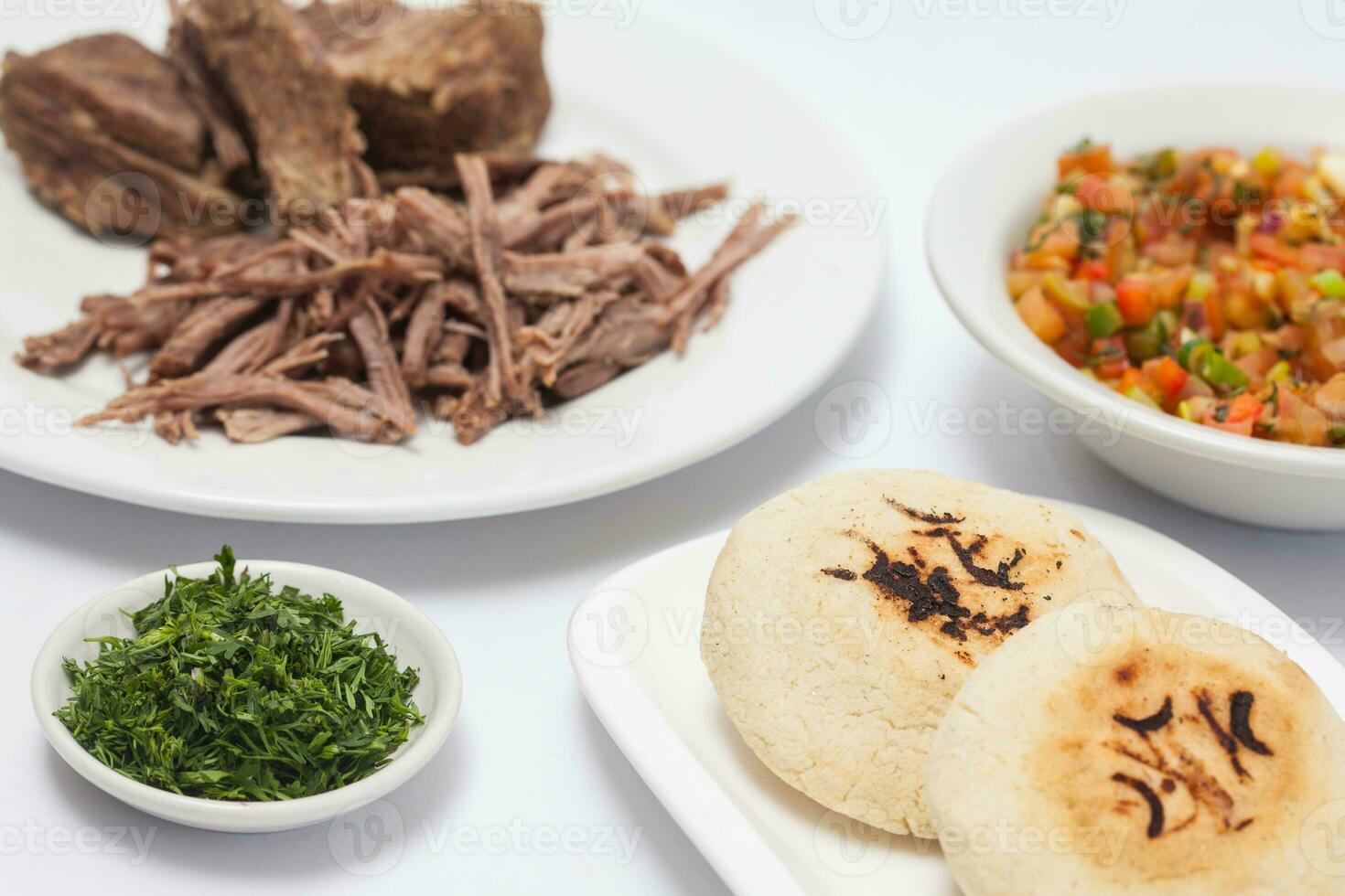 Stuffed Colombian arepa preparation. Colombian arepas and shredded beef photo