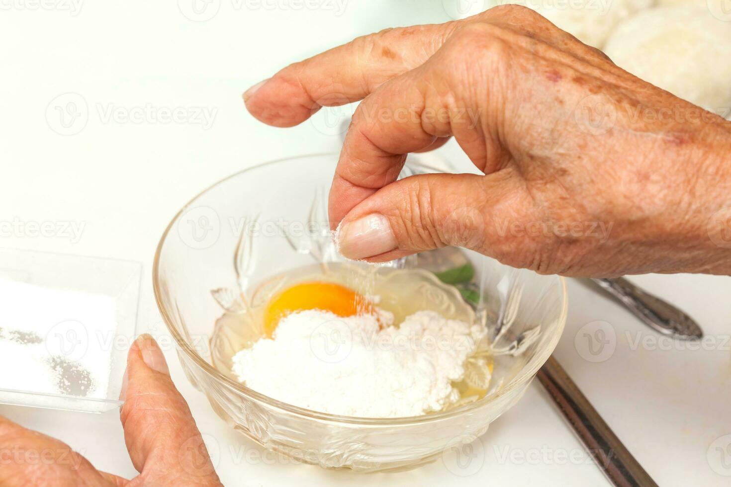 Preparation steps of traditional Colombian dish called stuffed potatoes. Preparing the egg and flour mixture to dunk potatoes photo