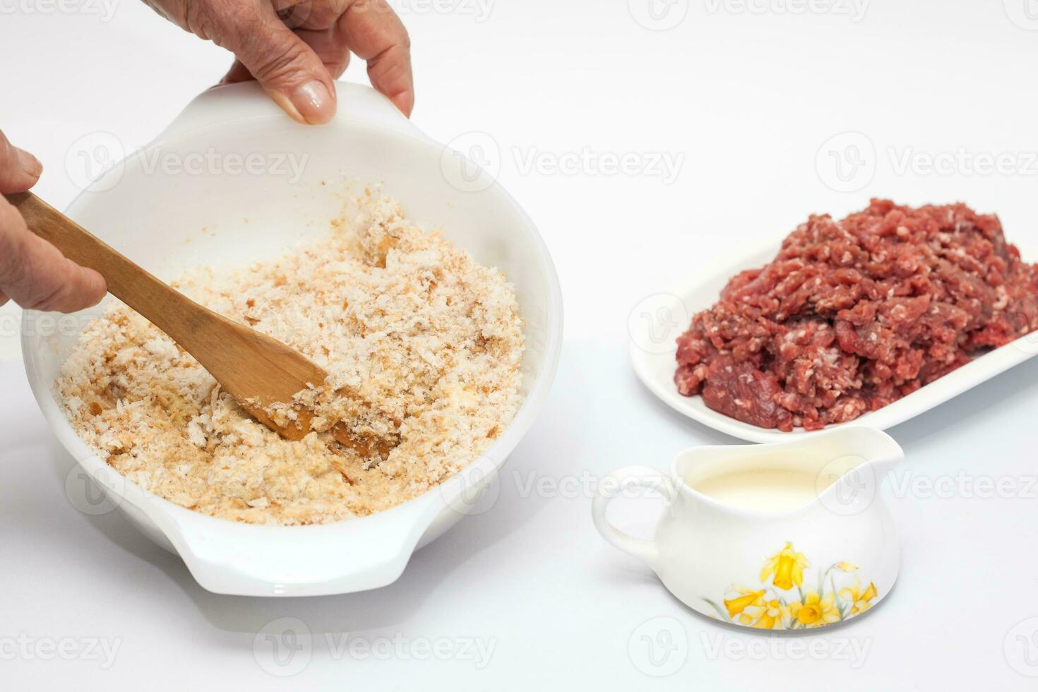 Preparation of a baked egg and vegetables stuffed meatloaf covered with bacon. Meat roll photo