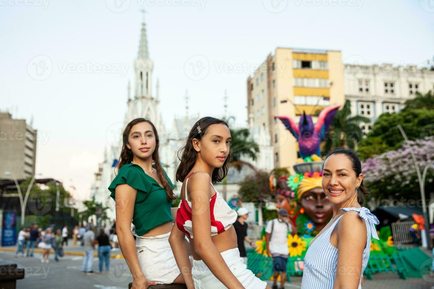 Tourists at the River Boulevard with La Ermita church on background in the city of Cali in Colombia. Christmas decoration. photo