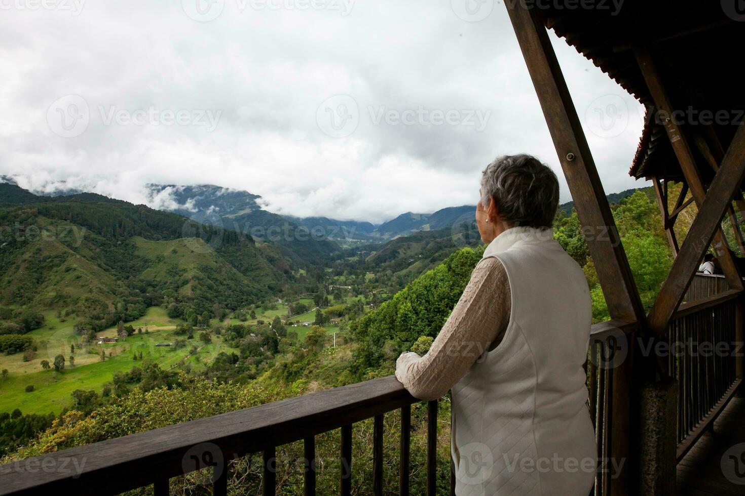 Senior woman at the beautiful view point over the Cocora Valley in Salento, located on the region of Quindio in Colombia photo