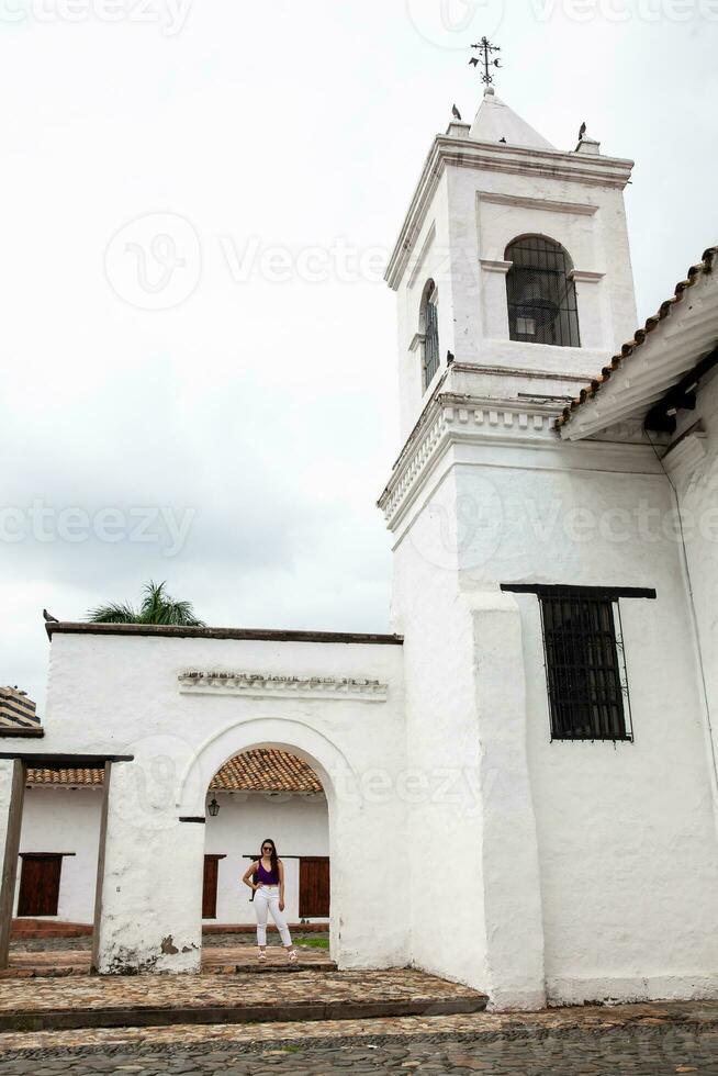 Beautiful young woman at the historical La Merced Church located in the Cali city downtown in Colombia photo