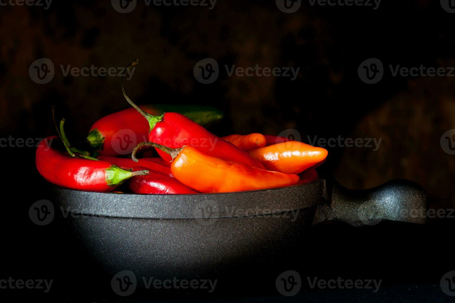 Red hot chili peppers on black background photo