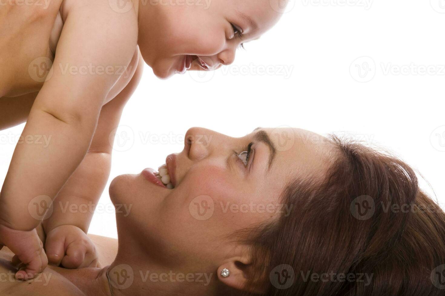 Happy beautiful young mother and her baby girl on white background photo