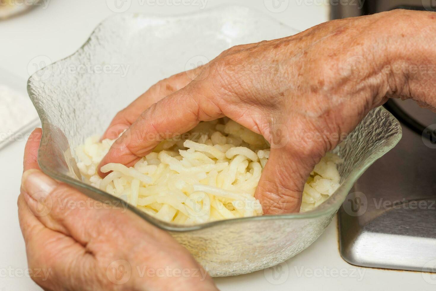 Preparation steps of traditional Colombian dish called stuffed potatoes. Kneading the mashed potatoes by hand to form a dough for the stuffed potatoes photo