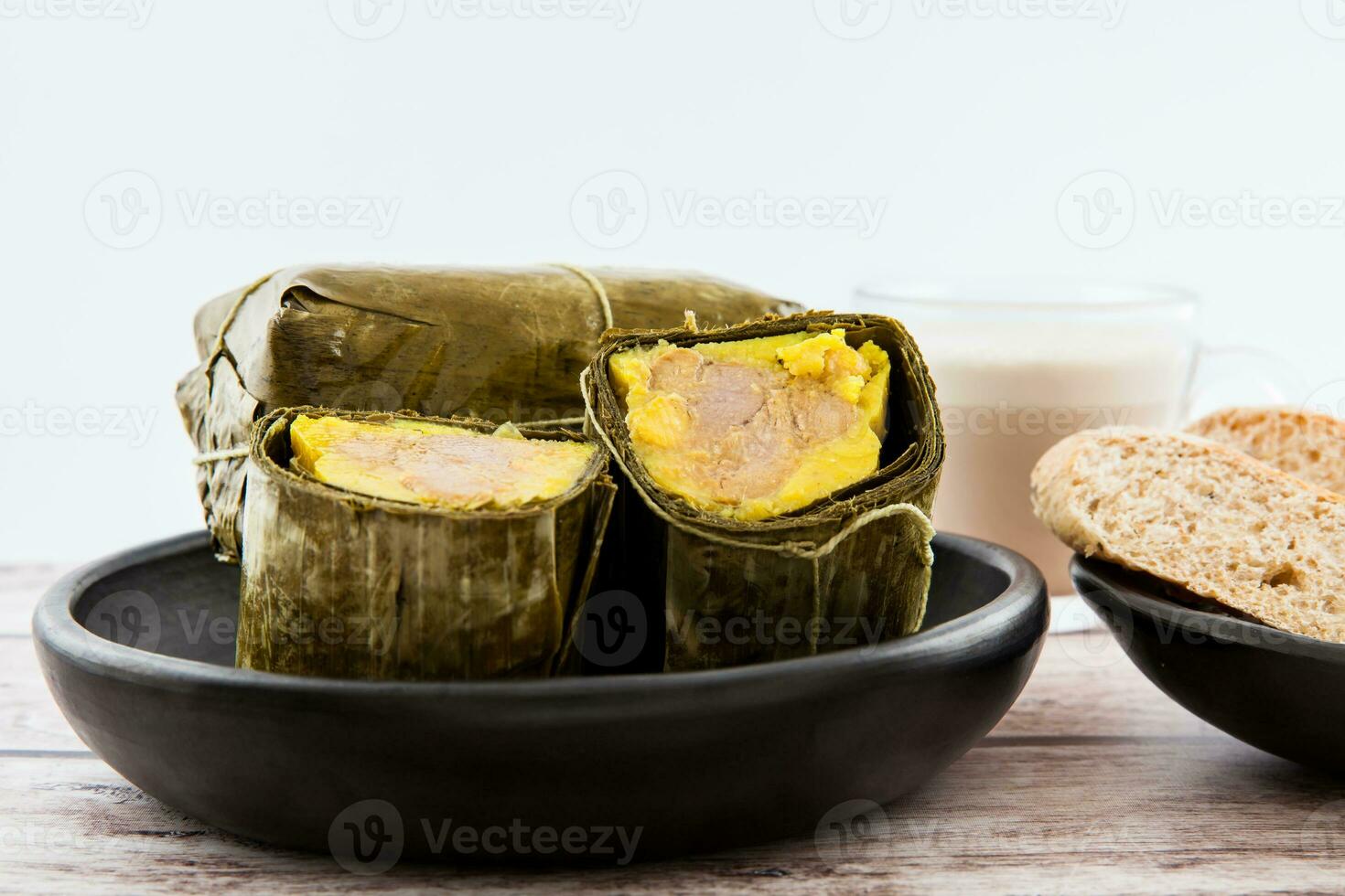 Traditional Colombian tamale breakfast with bread and chocolate as made on Santander region isolated on white background photo