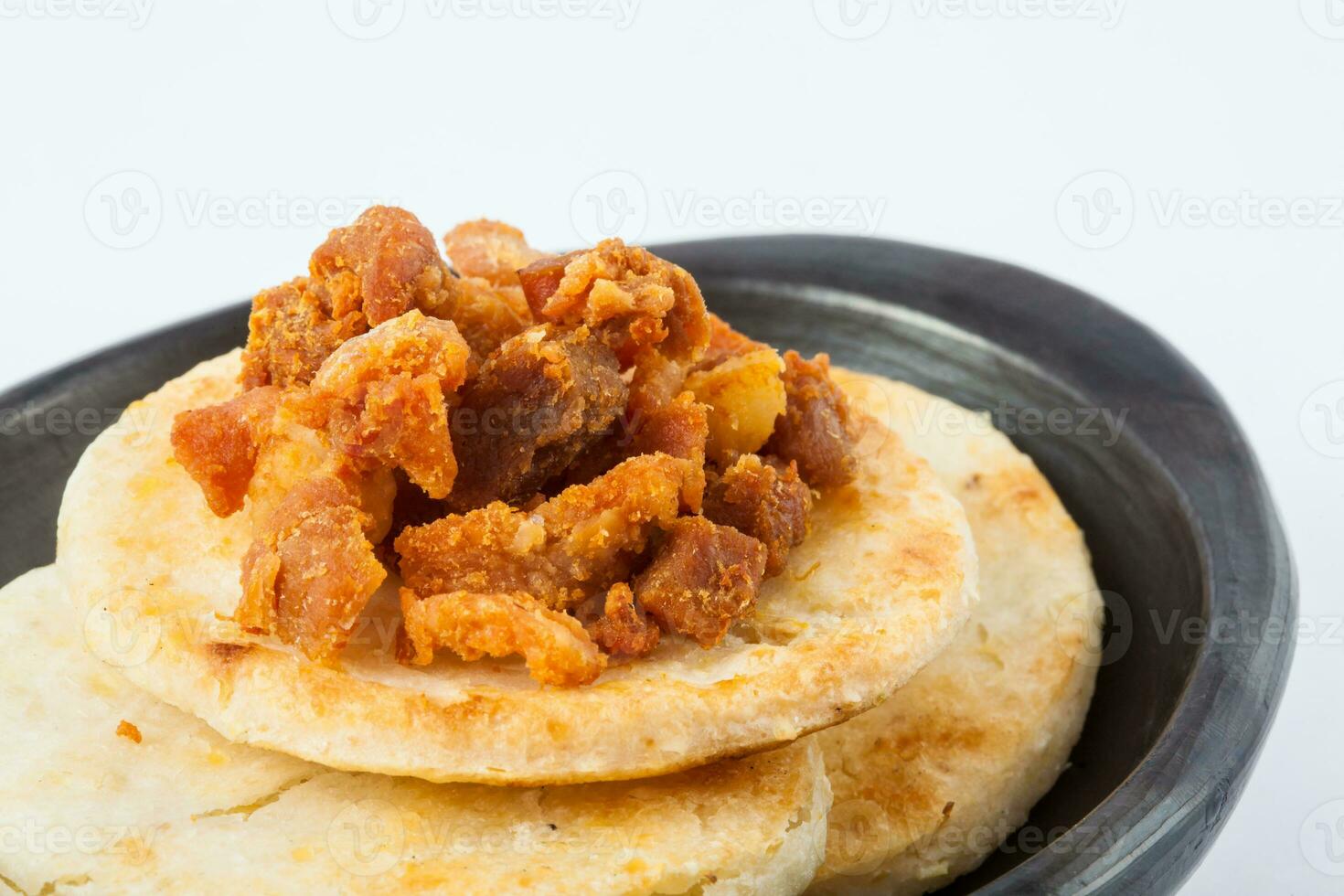 Traditional Colombian arepa topped with pork rind photo