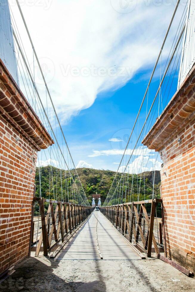 The historical Bridge of the West a a suspension bridge declared Colombian National Monument built in 1887 over the Cauca River photo
