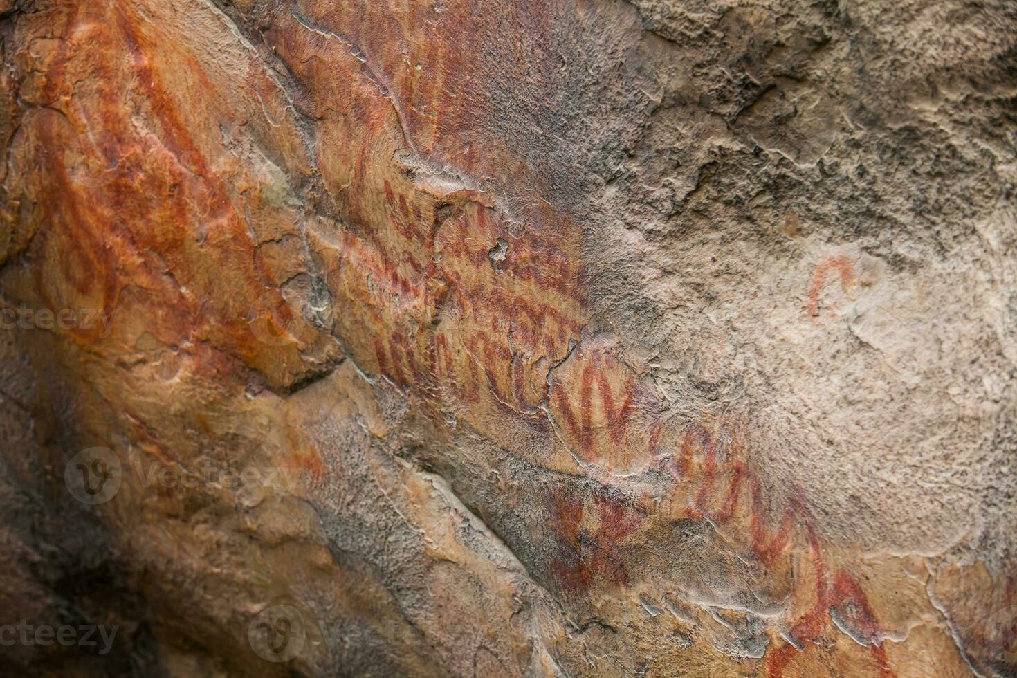 Prehistoric paintings on rock known as petroglyphs in Colombia photo