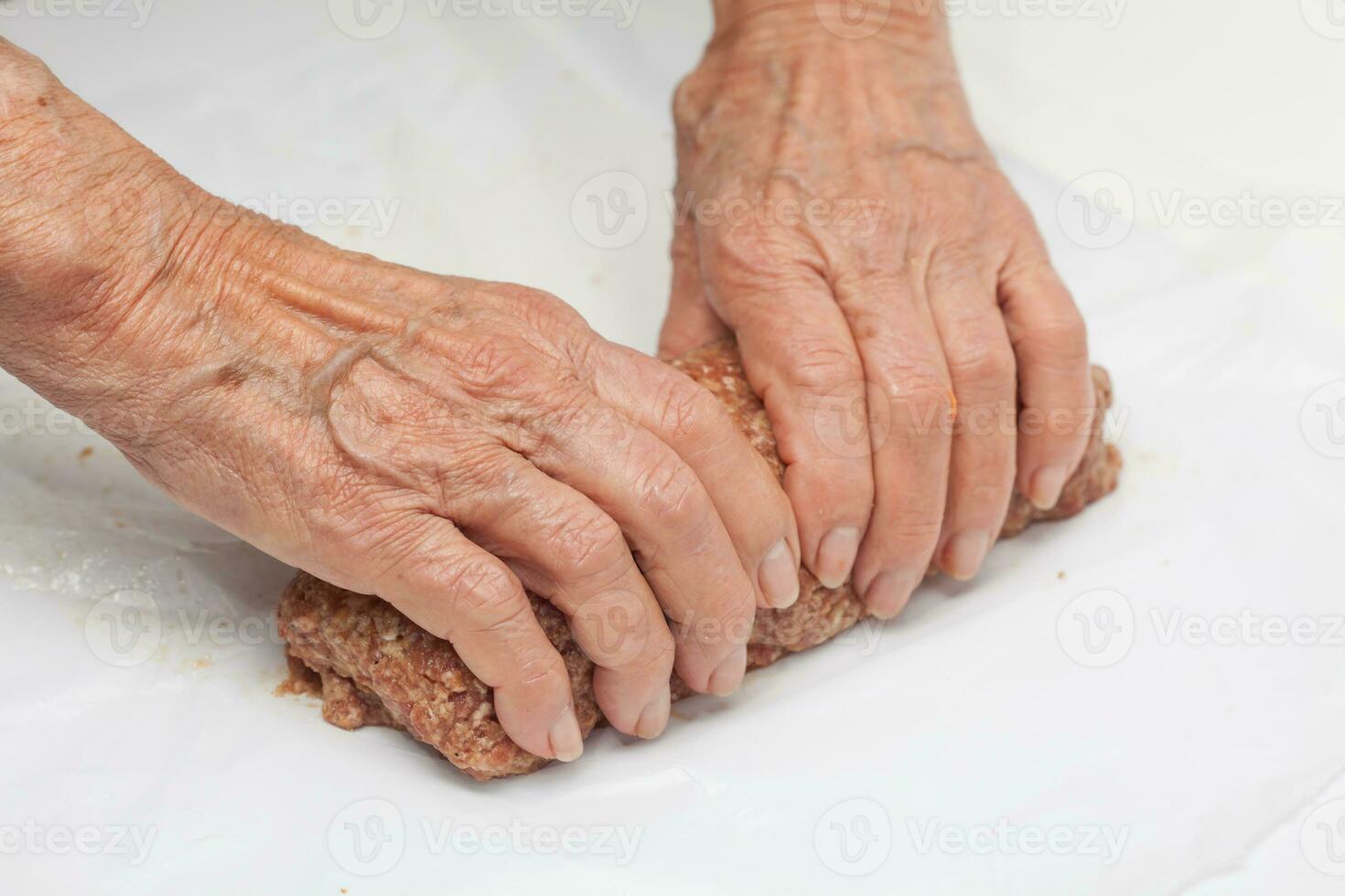 Preparation of a baked egg and vegetables stuffed meatloaf covered with bacon. Meat roll photo