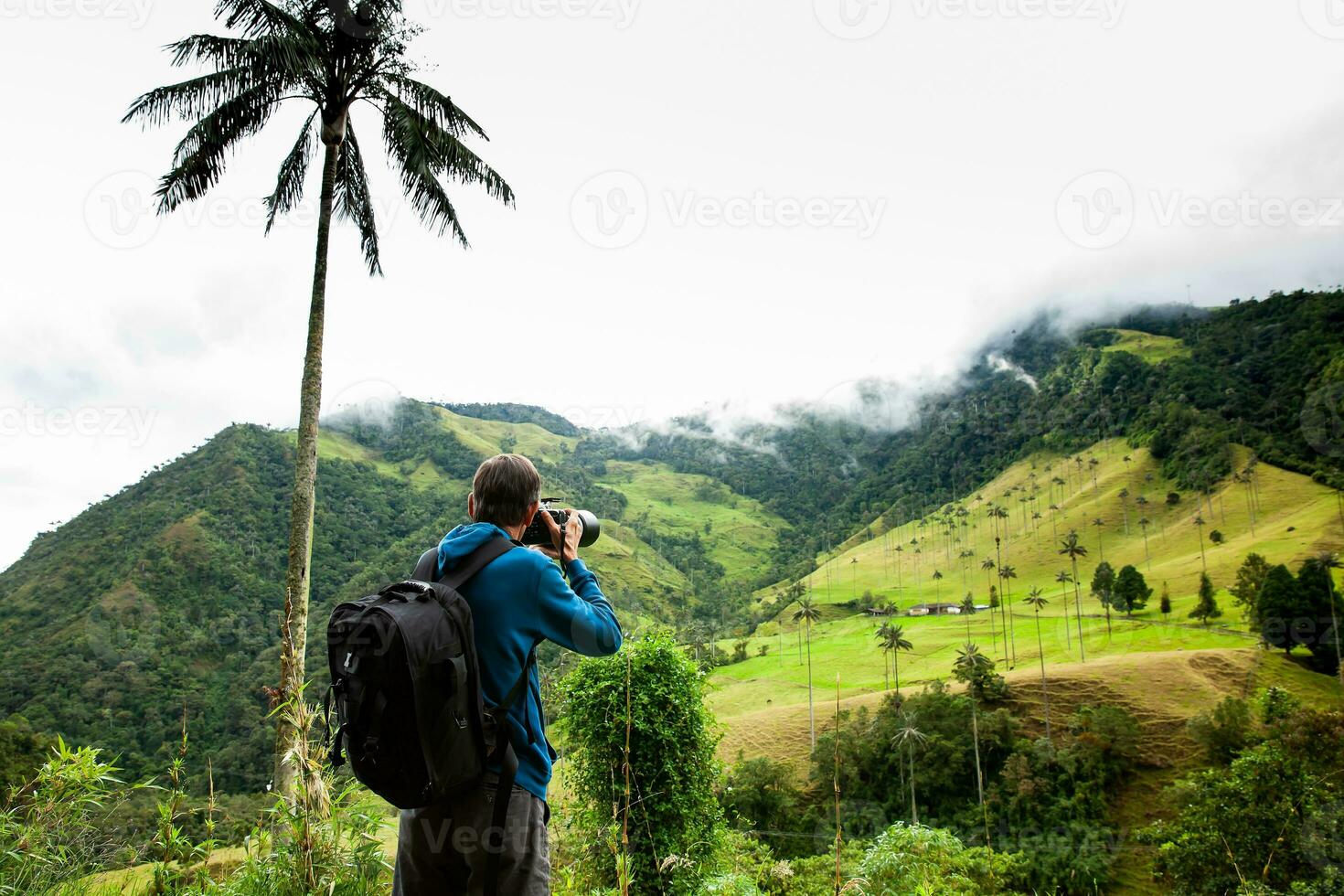 Tourist taking pictures at the beautiful Valle de Cocora located in Salento at the Quindio region in Colombia photo