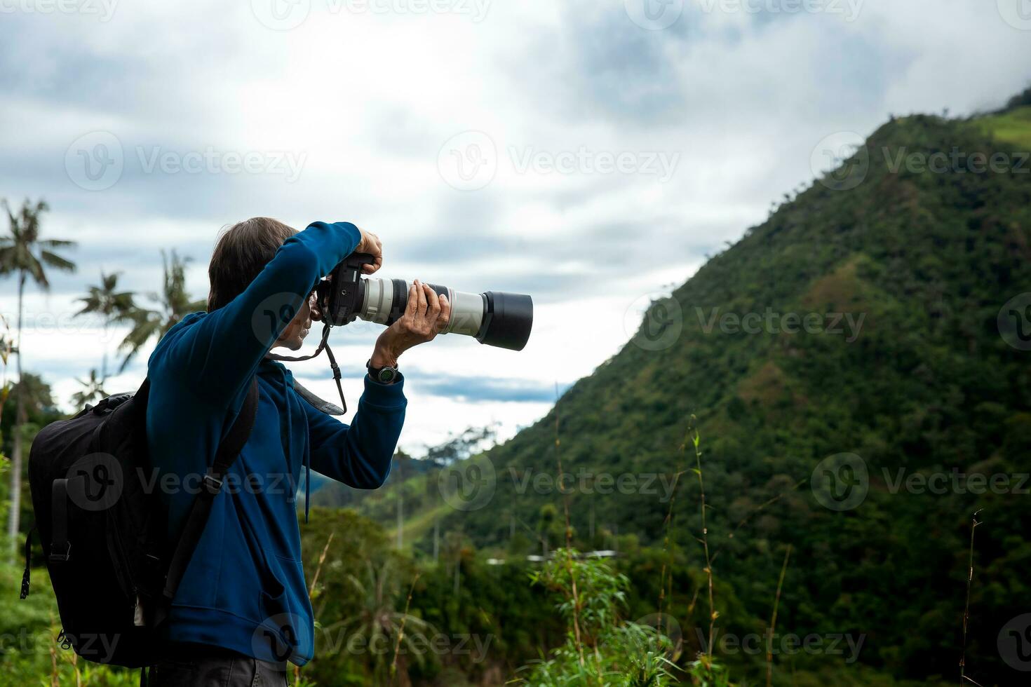 Tourist taking pictures at the beautiful Valle de Cocora located in Salento at the Quindio region in Colombia photo