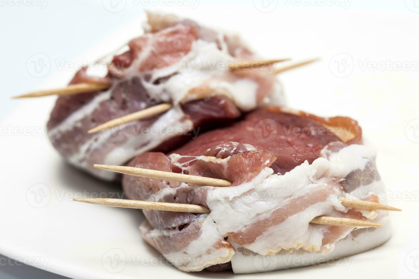 Raw beef tenderloin medallions wrapped in pork bacon. Fillet Mignon Preparation photo