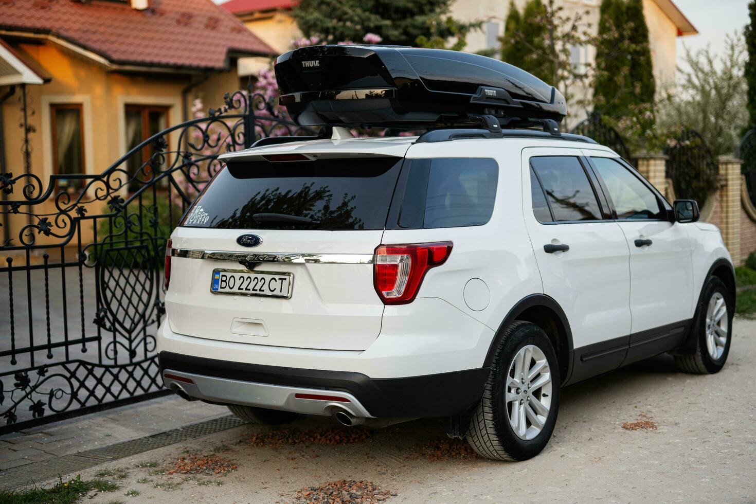 Ford Explorer family car with roof rack Thule Motion XXL box in ukrainian license plates. photo