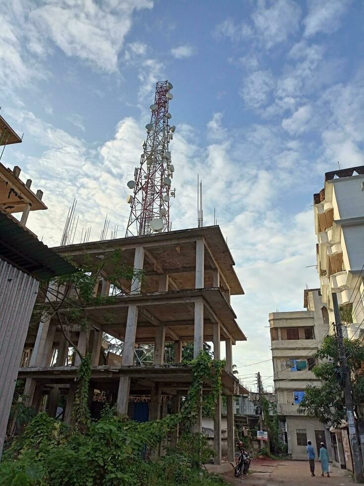 A building with a radio tower in the background. photo