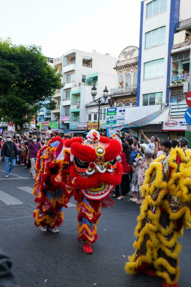 Ho Chi Minh city, Vietnam - 6 Feb 2023 Lunar New Year celebration - The dragon dance, beautiful colorful festive figure. Tet holiday background. Chinese Lunar New Year's Day, Spring Festival. photo