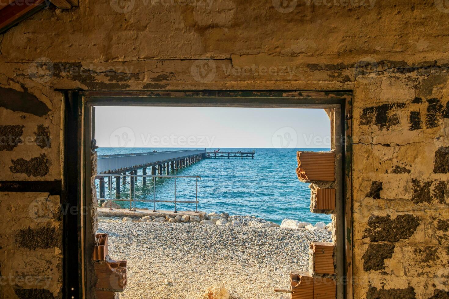 Pier through a rusted window photo