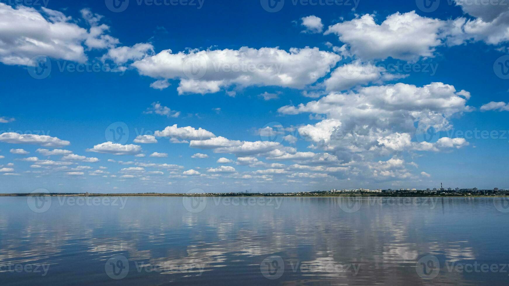 Seascape Sea with calm water and white clouds photo