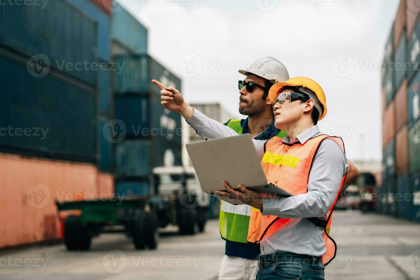 Team Engineer and worker wear safety uniform check control loading freight cargo container use computer laptop at commercial dock warehouse,transportation import,export logistic industrial service photo