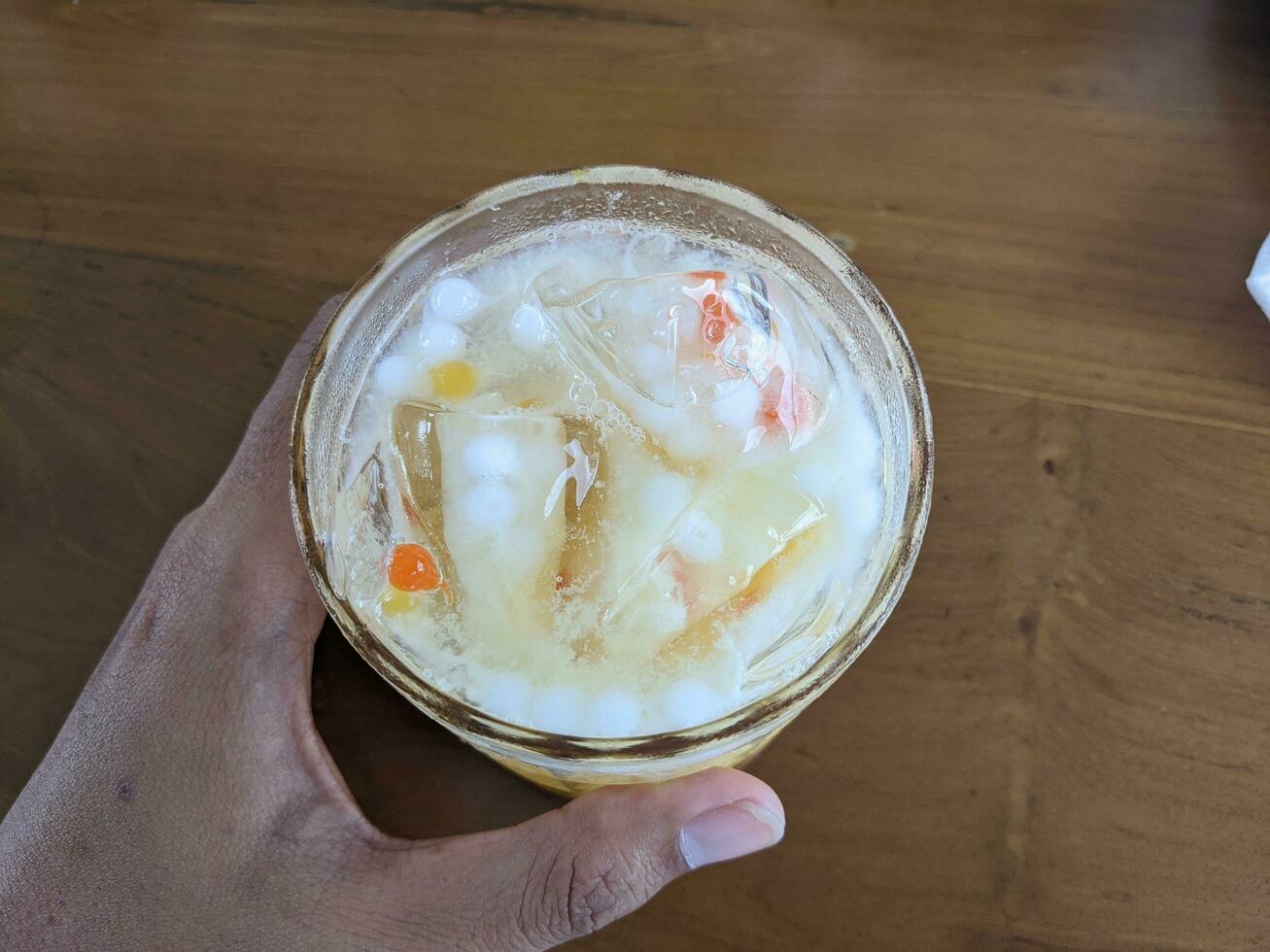 Yakult mango ice with fresh milk and little pulpy. The photo is suitable to use for coffee shop background, menu poster and coffee content media.