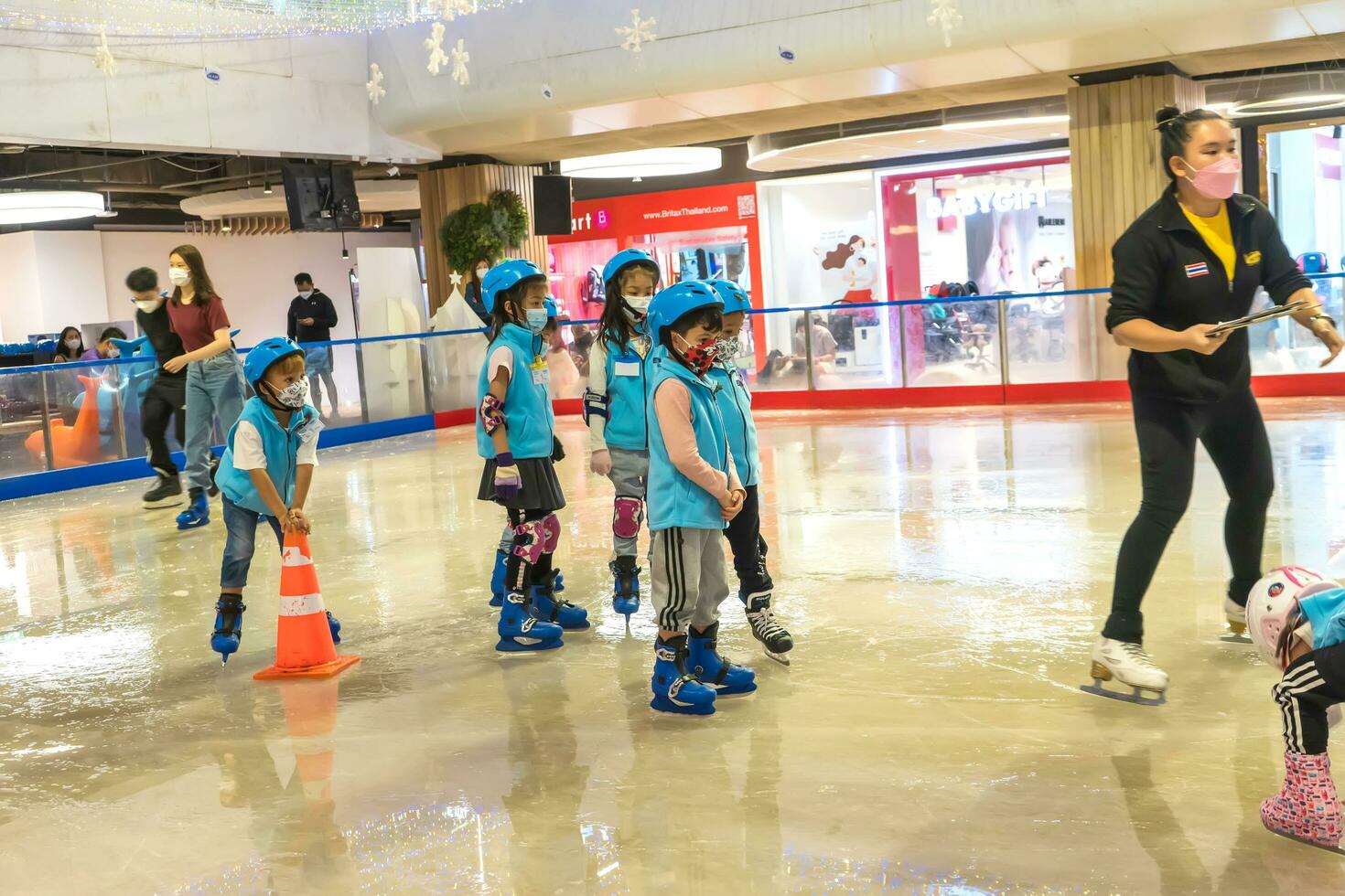 Bangkok, Thailand - APR 30, 2022 - Many children are practicing ice skating at Seacon Square, Bangkok, Thailand. photo