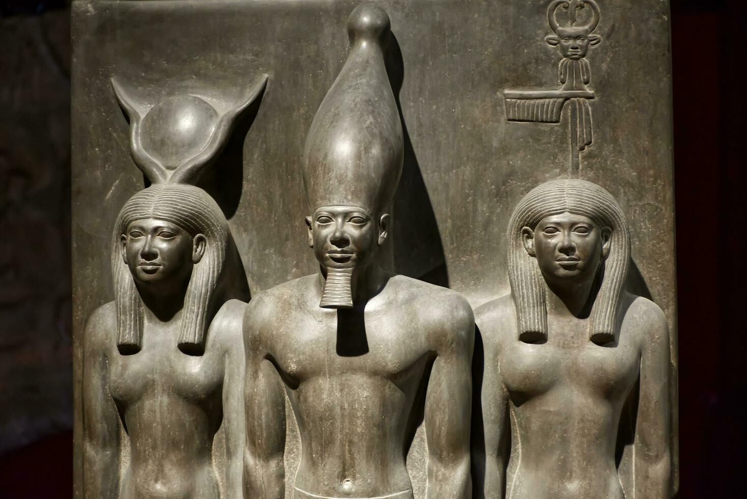 Cairo, Egypt , March 18, 2023  Statue of King Menkaura, goddess Hathor and Bat. The Egyptian Museum in Cairo. photo