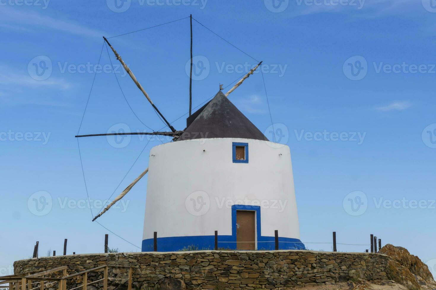 Old restored windmill in Aljezur, Portugal, against of the blue sky photo